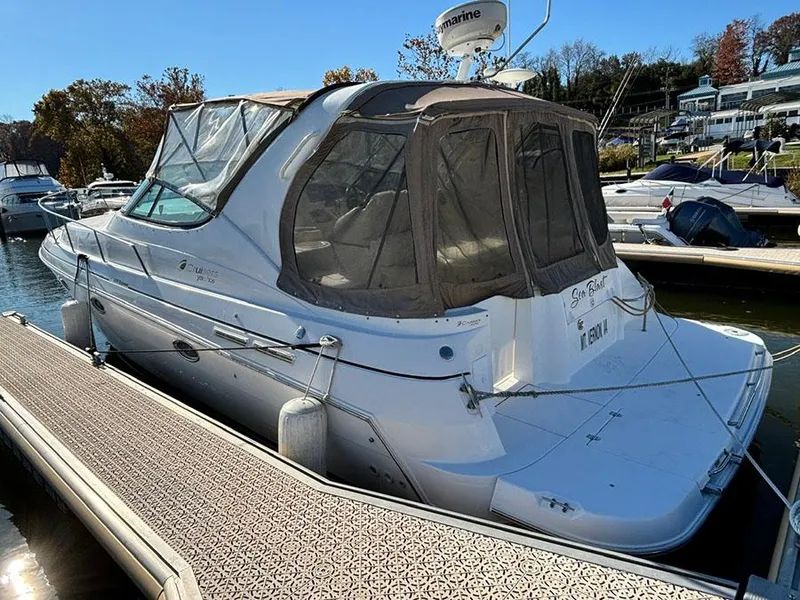 Slide: The Image of 2000 Cruisers Yachts 3375 Express docked at marina, covered cabin, clear day. - 4