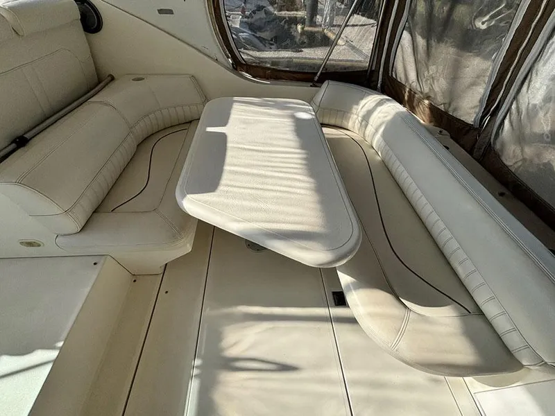 Slide: The Image of 2000 Cruisers Yachts 3375 Express interior with cream leather seating and table. - 8