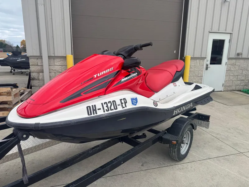 Slide: The Image of 2006 Honda Aquatrax F-12X jet ski on trailer, red and white design. - 1