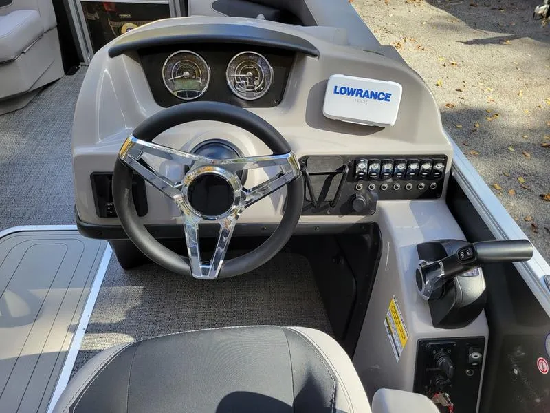 Slide: The Image of 2025 Barletta A20QC boat dashboard with steering wheel and Lowrance navigation system. - 17