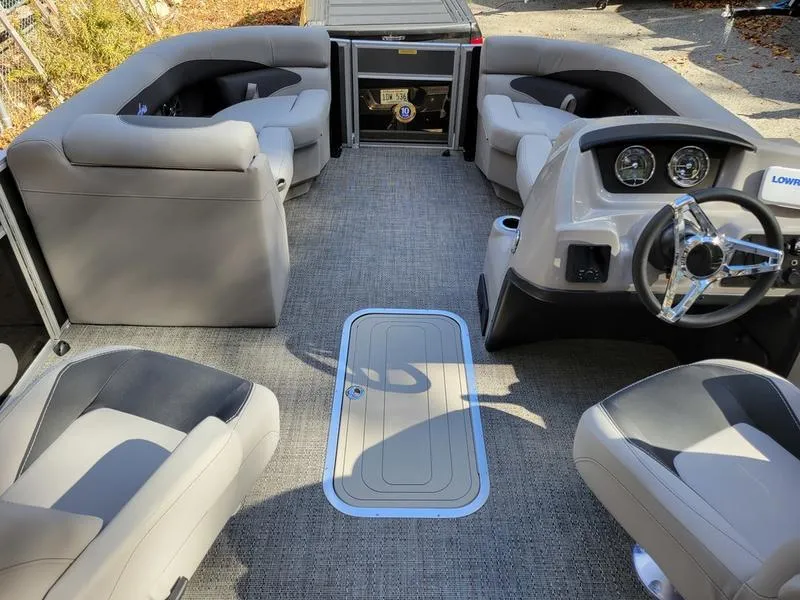 Slide: The Image of 2025 Barletta A20QC pontoon boat interior with plush seating and modern dashboard. - 25