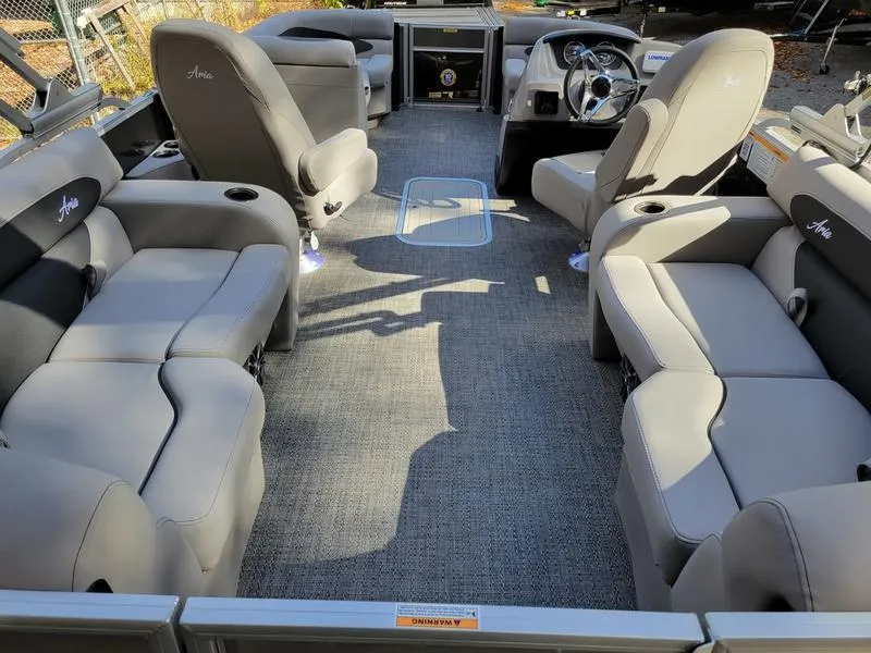 Slide: The Image of 2025 Barletta A20QC pontoon boat interior with plush seating and modern dashboard. - 26