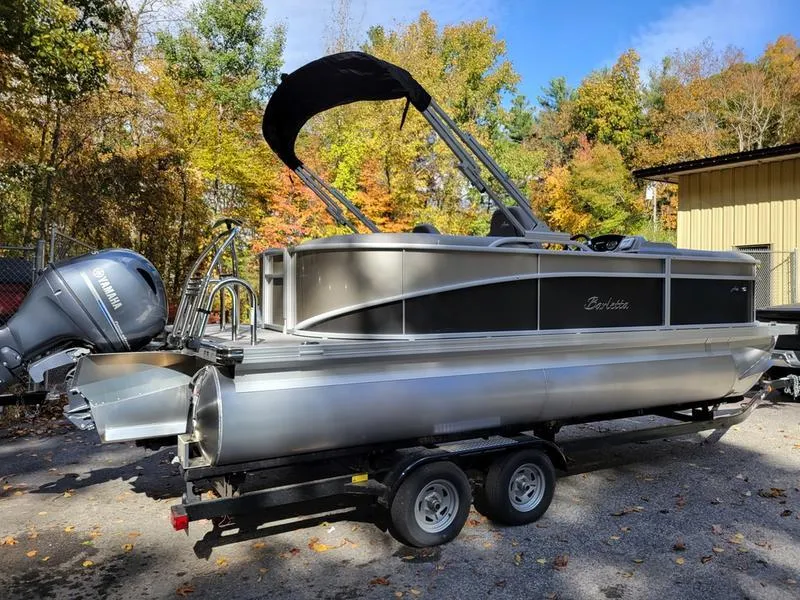 Slide: The Image of 2025 Barletta A20QC pontoon boat on trailer, surrounded by autumn trees. - 7