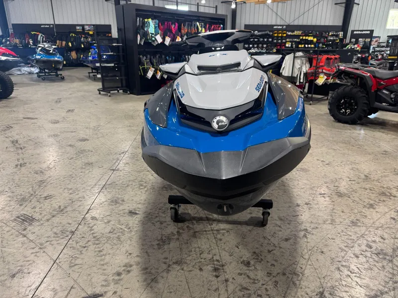 Slide: The Image of 2020 Sea-Doo GTX 230 jet ski in showroom, blue and gray design. - 2