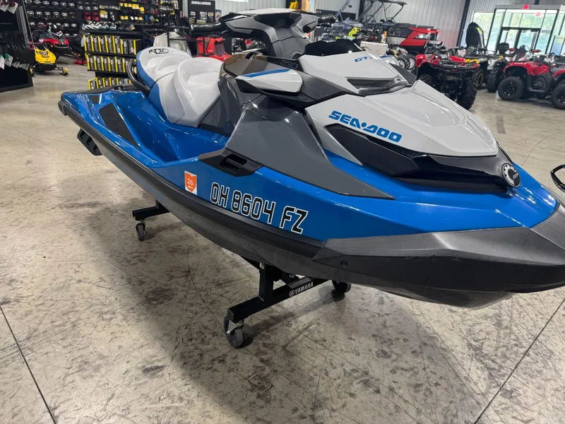 Slide: The Image of 2020 Sea-Doo GTX 230 jet ski in showroom, blue and gray design. - 3