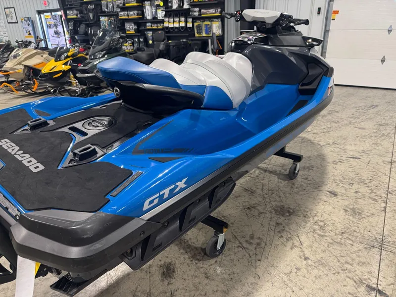 Slide: The Image of 2020 Sea-Doo GTX 230 jet ski in showroom, blue and black design. - 4
