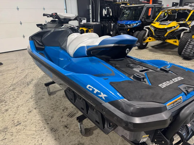 Slide: The Image of 2020 Sea-Doo GTX 230 jet ski in a showroom, blue and black design. - 5