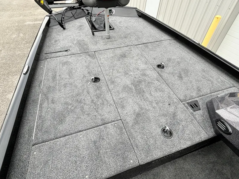 Slide: The Image of 2024 Ranger RT188 boat deck with gray carpet and storage compartments. - 5