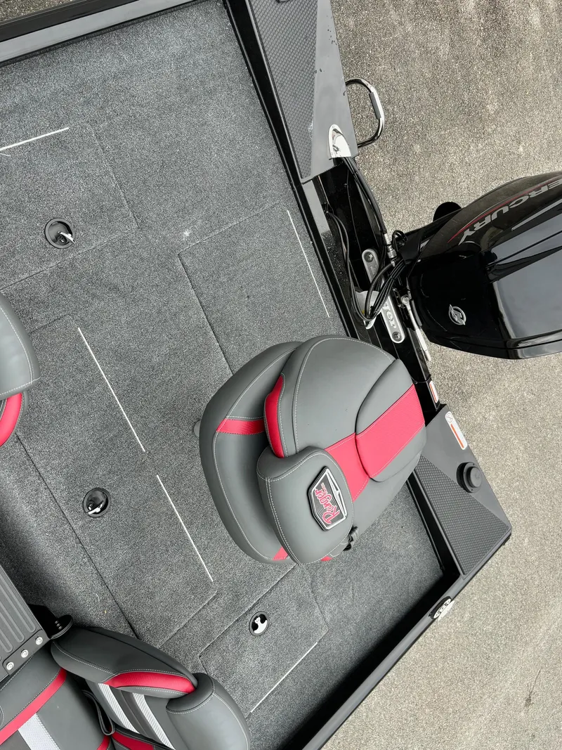 Slide: The Image of 2024 Ranger RT188 boat interior with red and gray seating, featuring a sleek motor. - 9