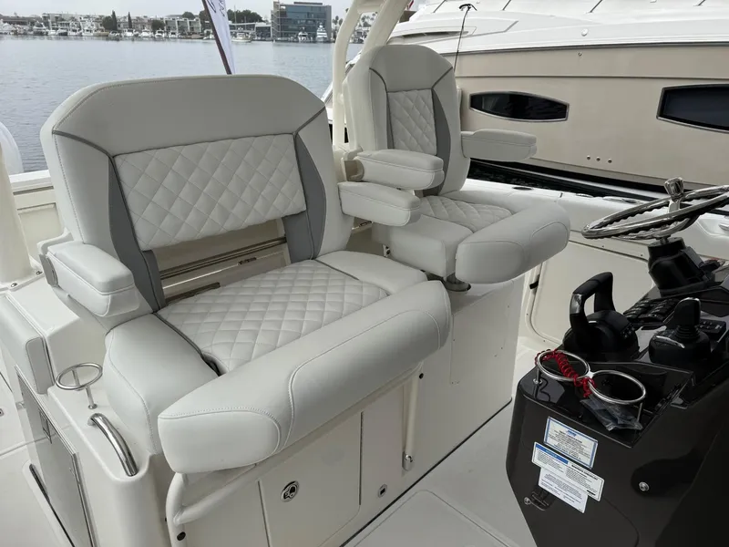 Slide: The Image of Luxurious seating on 2025 Pursuit S 328 Sport boat, featuring quilted upholstery. - 10