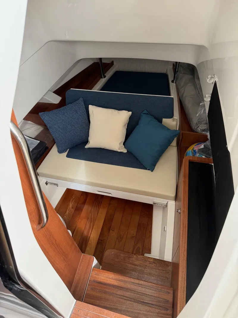 Slide: The Image of 2025 Pursuit S 328 Sport cabin interior with cozy seating and cushions. - 13