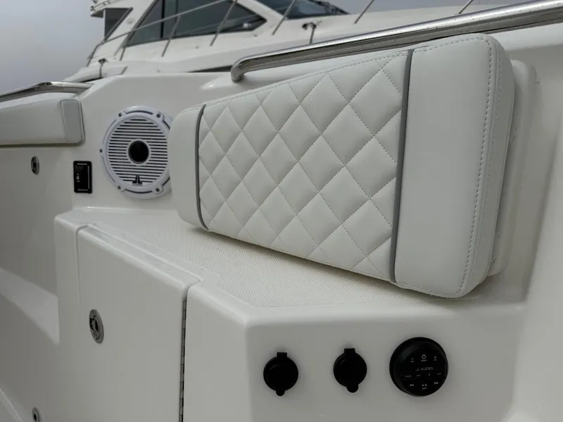 Slide: The Image of 2025 Pursuit S 328 Sport boat interior with quilted seating and audio controls. - 18
