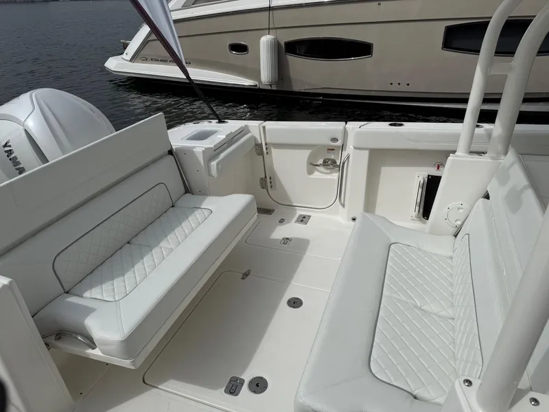 Slide: The Image of 2025 Pursuit S 328 Sport boat interior with white seating and Yamaha engine. - 7