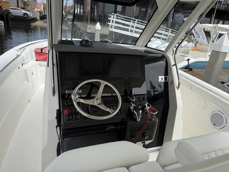 Slide: The Image of 2025 Pursuit S 328 Sport boat cockpit with modern steering and controls. - 9
