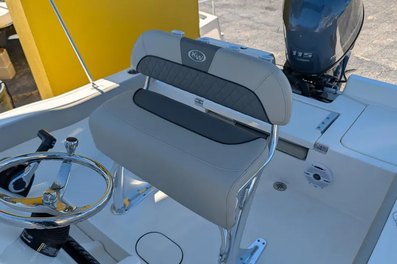 Slide: The Image of 2026 Key West 179 FS boat interior with steering wheel and seating. - 10