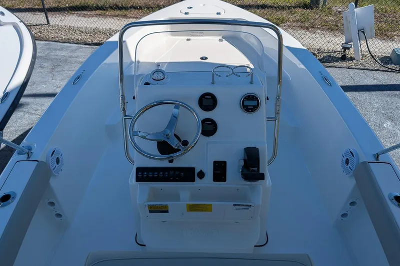 Slide: The Image of 2026 Key West 179 FS boat console with steering wheel and gauges. - 11