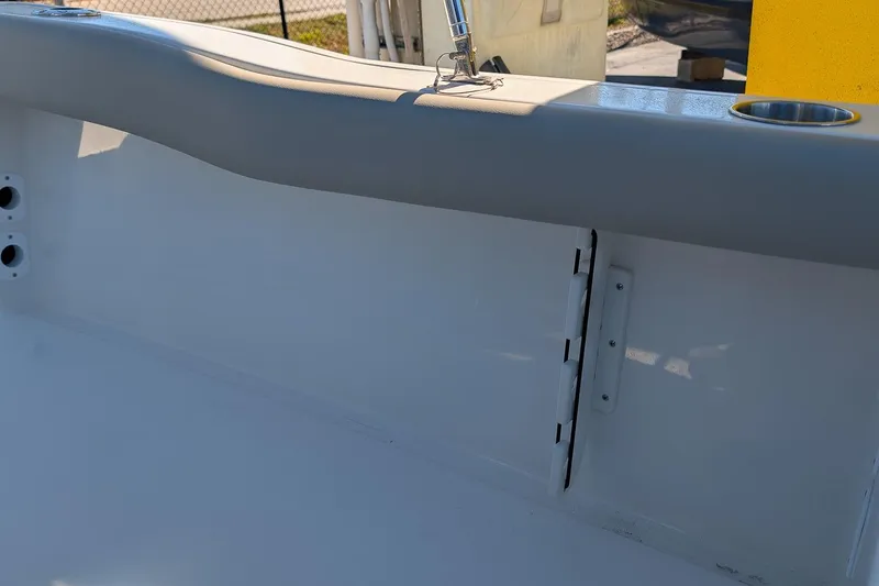 Slide: The Image of 2026 Key West 179 FS boat interior detail with cup holder and hinge. - 9