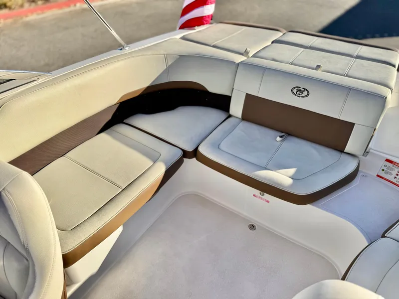 Slide: The Image of 2017 Cobalt 220S boat interior with beige and brown seating. - 14