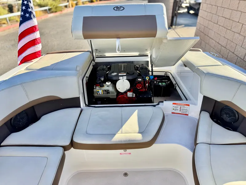 Slide: The Image of 2017 Cobalt 220S boat engine compartment with American flag, open seating area. - 18