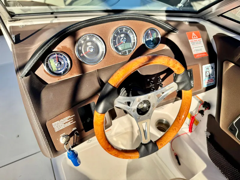 Slide: The Image of Steering wheel and dashboard of a 2017 Cobalt 220S boat. - 25