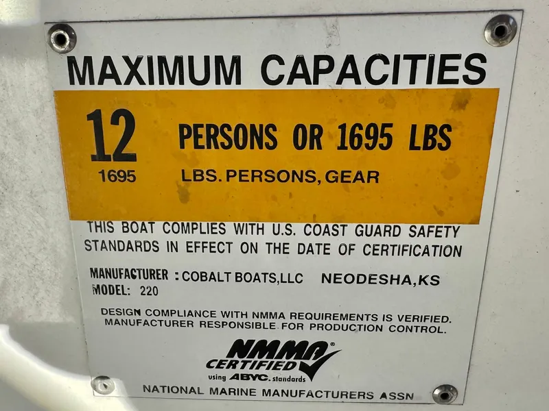 Slide: The Image of Cobalt 220S 2017 boat capacity label: 12 persons or 1695 lbs, NMMA certified. - 26