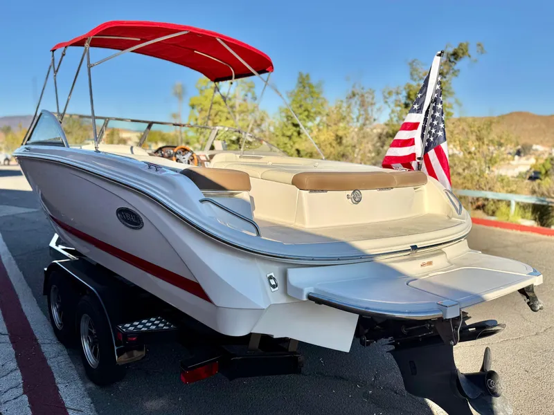 Slide: The Image of 2017 Cobalt 220S boat with red canopy and American flag on trailer. - 4