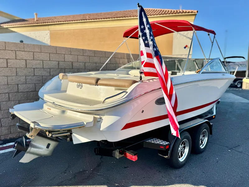 Slide: The Image of 2017 Cobalt 220S boat with American flag, red canopy, on trailer. - 6