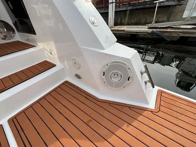 Slide: The Image of 2023 NX Boats 360 deck with wood finish and speaker system. - 14