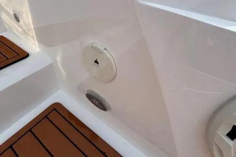 Slide: The Image of 2023 NX Boats 360 deck with shower feature and teak flooring. - 15