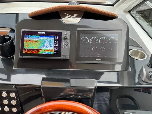 Slide: The Image of 2023 NX Boats 360 dashboard with Simrad and Garmin displays. - 20