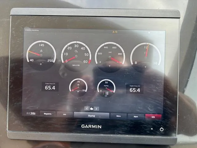 Slide: The Image of Garmin display showing engine metrics on 2023 NX Boats 360 dashboard. - 21