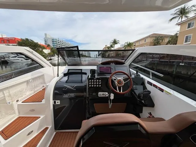 Slide: The Image of 2023 NX Boats 360 cockpit with modern controls and waterfront view. - 22