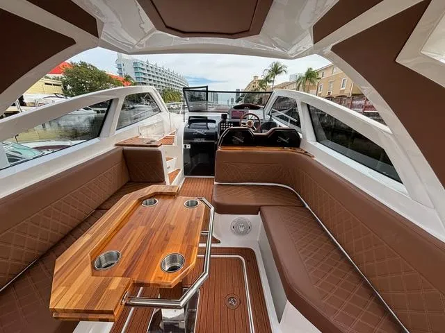 Slide: The Image of Luxurious interior of 2023 NX Boats 360 with elegant seating and wooden table. - 25