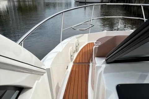 Slide: The Image of 2023 NX Boats 360 with sleek deck design and wood accents on calm water. - 29