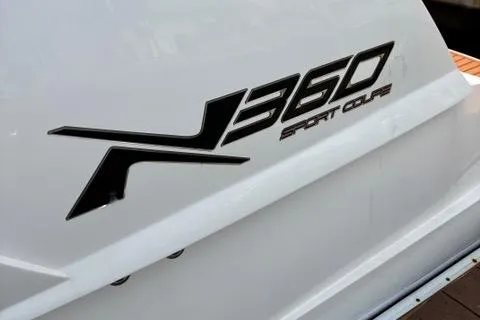 Slide: The Image of 2023 NX Boats 360 Sport Coupe logo on white hull. - 32