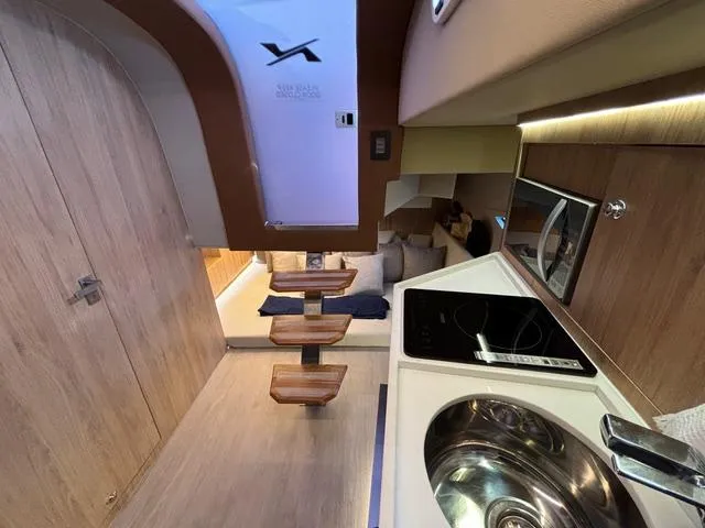 Slide: The Image of Interior of 2023 NX Boats 360, featuring modern kitchen and seating area. - 38