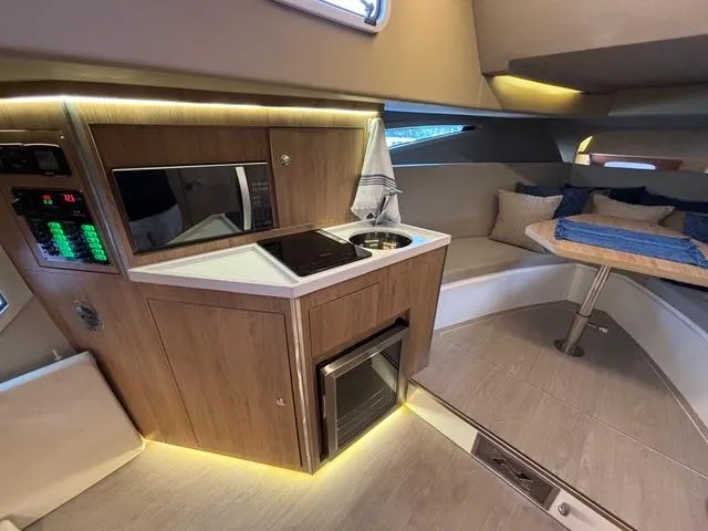 Slide: The Image of Luxurious interior of 2023 NX Boats 360 with modern kitchenette and cozy seating area. - 39