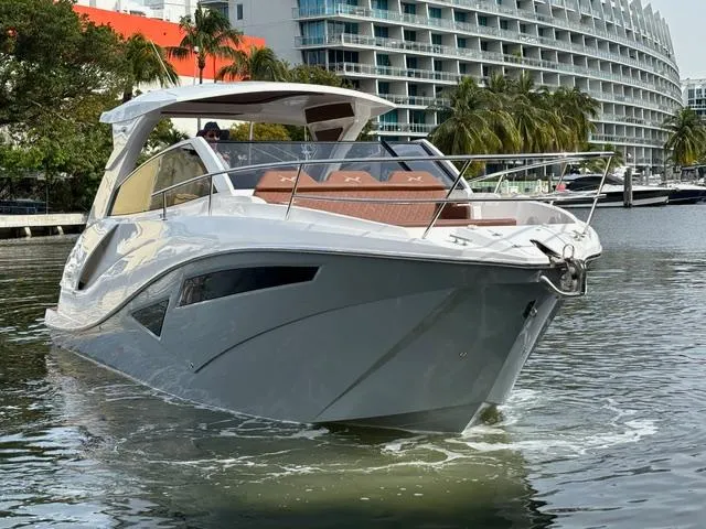 Slide: The Image of 2023 NX Boats 360 cruising in a marina, modern design, luxury yacht. - 4