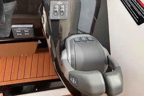 Slide: The Image of 2023 NX Boats 360 control panel with joystick and wooden accents. - 41