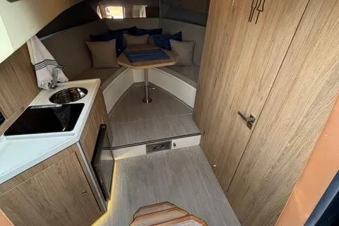 Slide: The Image of 2023 NX Boats 360 interior with kitchenette and cozy seating area. - 42