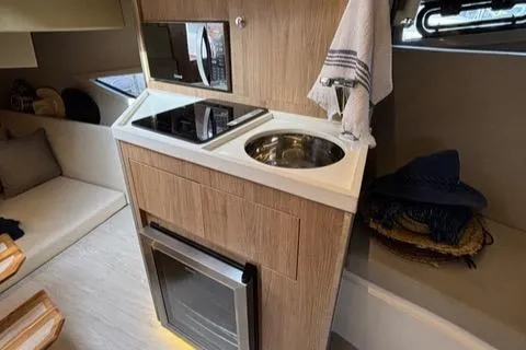 Slide: The Image of Modern kitchen area in 2023 NX Boats 360 yacht with stove and sink. - 43