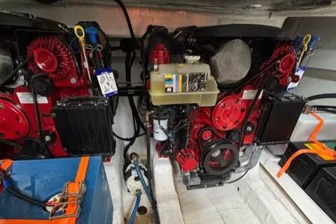 Slide: The Image of Engine room of 2023 NX Boats 360, featuring dual red engines and mechanical components. - 46