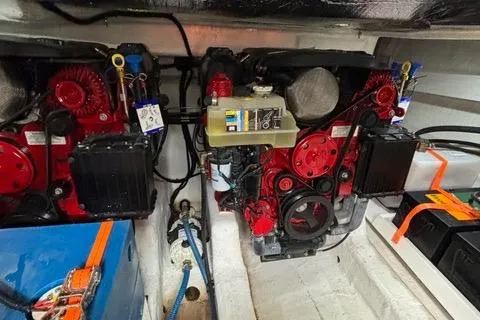 Slide: The Image of Engine compartment of 2023 NX Boats 360, featuring dual red engines and wiring. - 48
