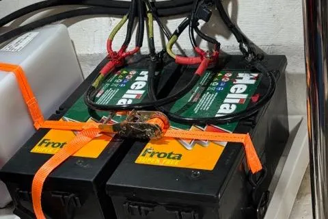 Slide: The Image of Batteries in NX Boats 360, 2023 model, secured with orange straps. - 49