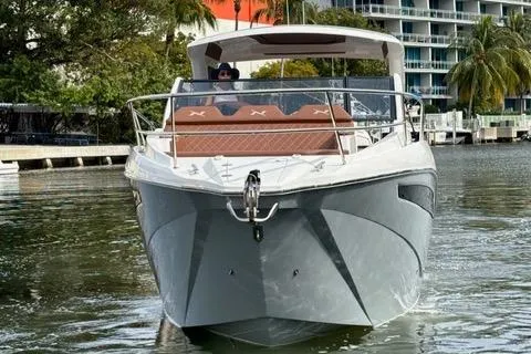 Slide: The Image of 2023 NX Boats 360 cruising on a calm waterway with modern design. - 5