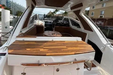 Slide: The Image of 2023 NX Boats 360 luxury yacht interior with sleek wood finish and modern design. - 7