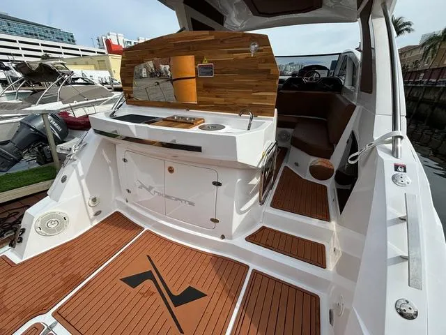 Slide: The Image of 2023 NX Boats 360 interior with wood accents and modern design. - 9