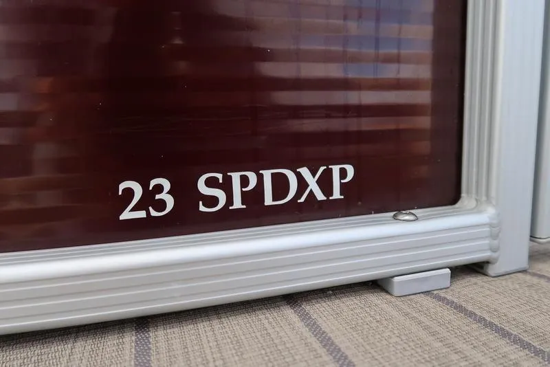 Slide: The Image of Bennington 23SPDXP 2018 model nameplate on a boat's exterior. - 18