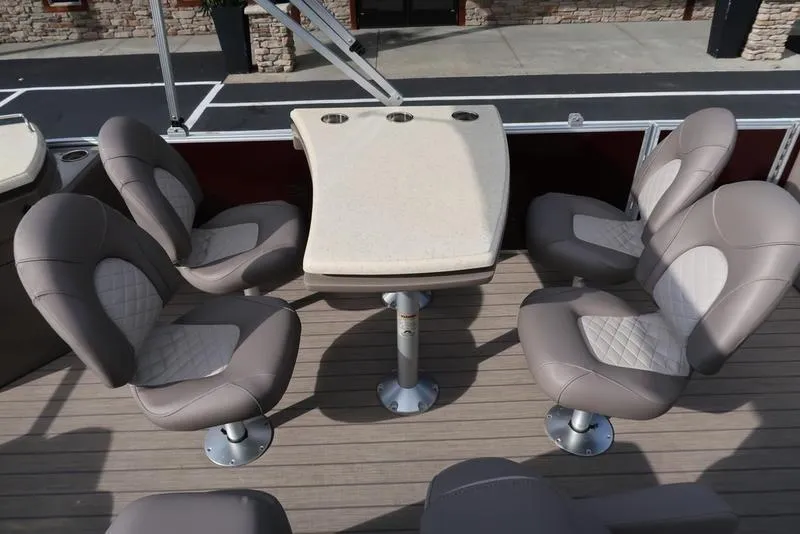 Slide: The Image of 2018 Bennington 23SPDXP boat interior with four cushioned seats and a central table. - 23