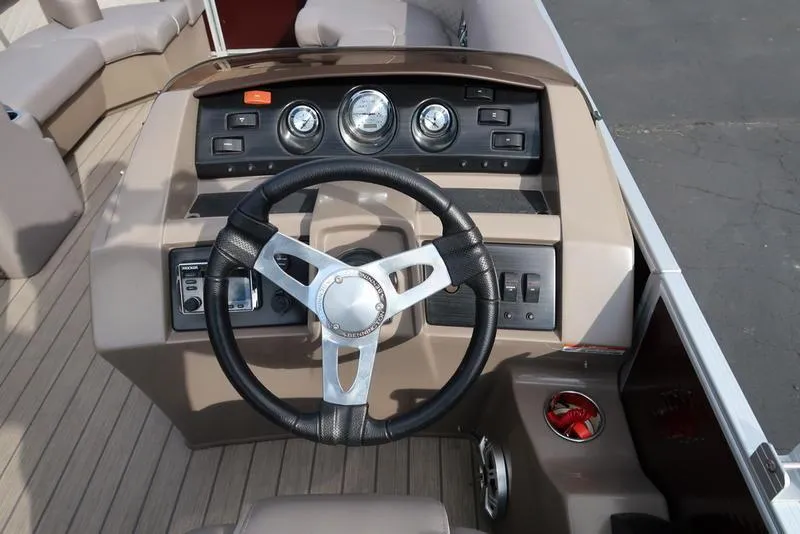 Slide: The Image of 2018 Bennington 23SPDXP boat dashboard with steering wheel and control panel. - 24